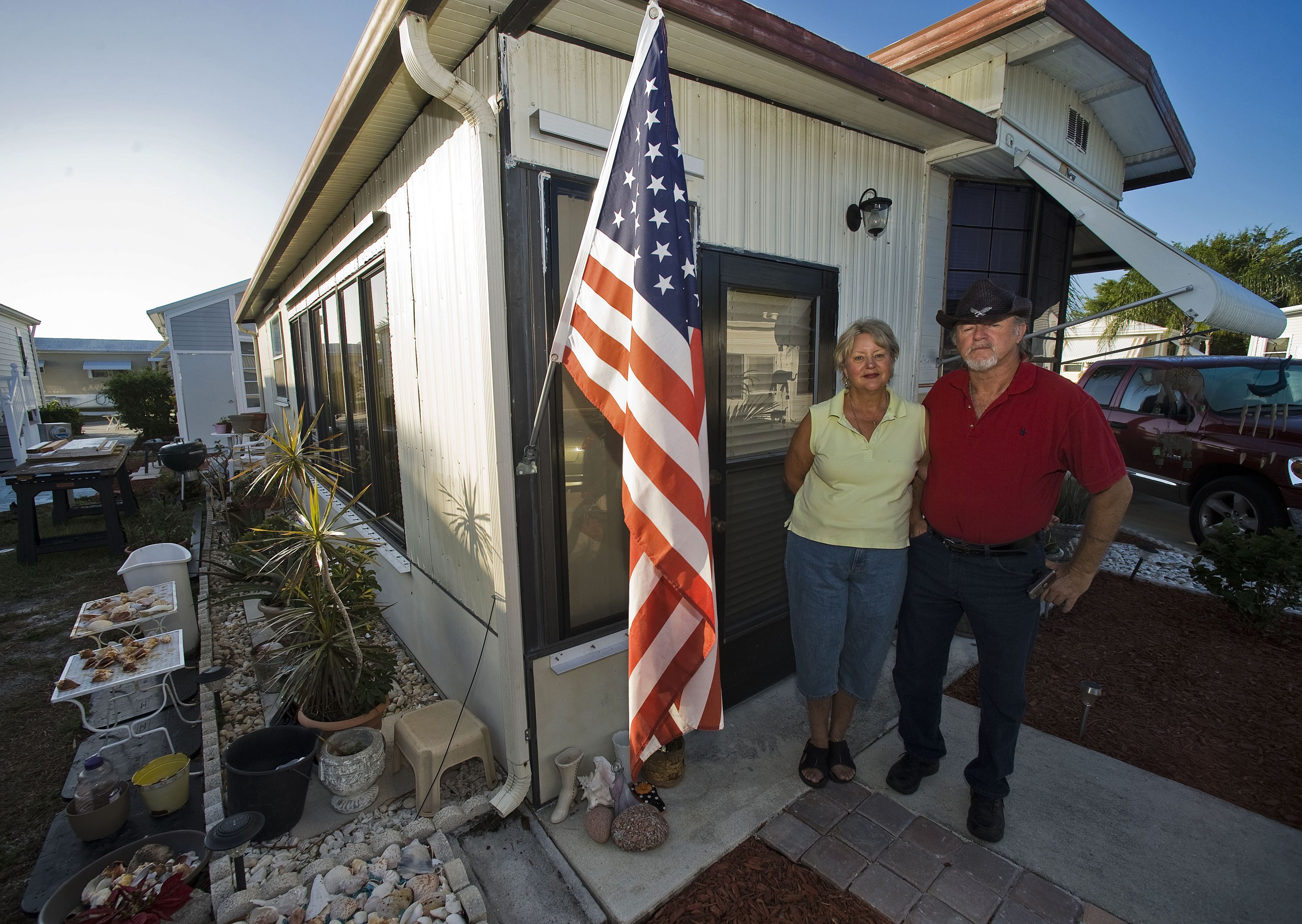 Andrea Davis and Dewey Schilling stand outside their home at Limetree Park where they live year-round in Bonita Springs, Florida, March 23, 2012. Davis, 63, a former secretary, said she hadn't worked long enough at one place to build up a 401K. "If it weren't for Social Security, I would probably be on the street," she added.