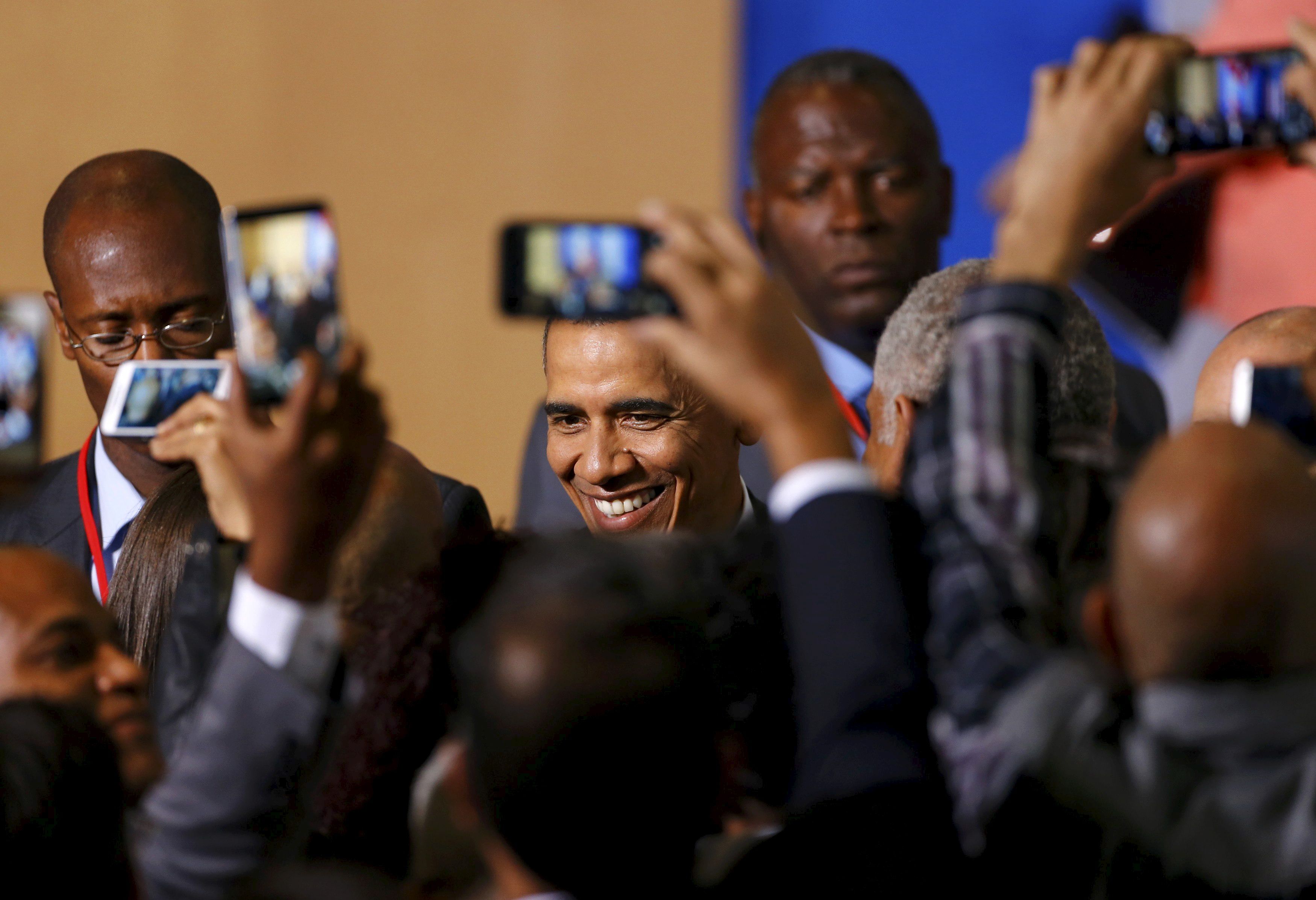 People take pictures of U.S. President Barack Obama (C) as he attends a meeting with entrepreneurs as part of his three-day visit to Cuba, in Havana March 21, 2016. REUTERS/Ivan Alvarado TPX IMAGES OF THE DAY - RTSBKC7